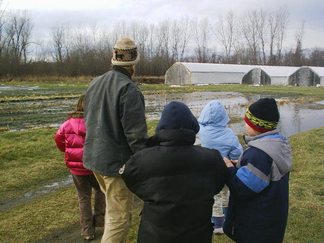 Teacher and students in wet field